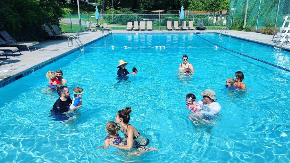 parents and their kids in the swimming pool 