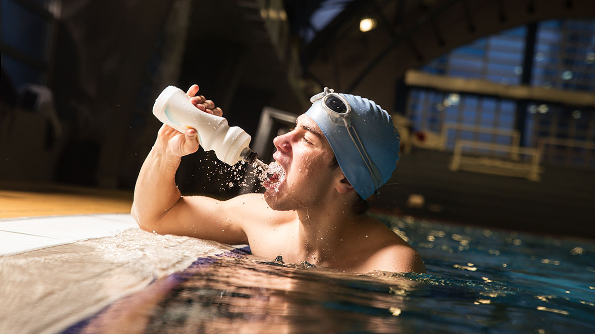 a man having water in the pool