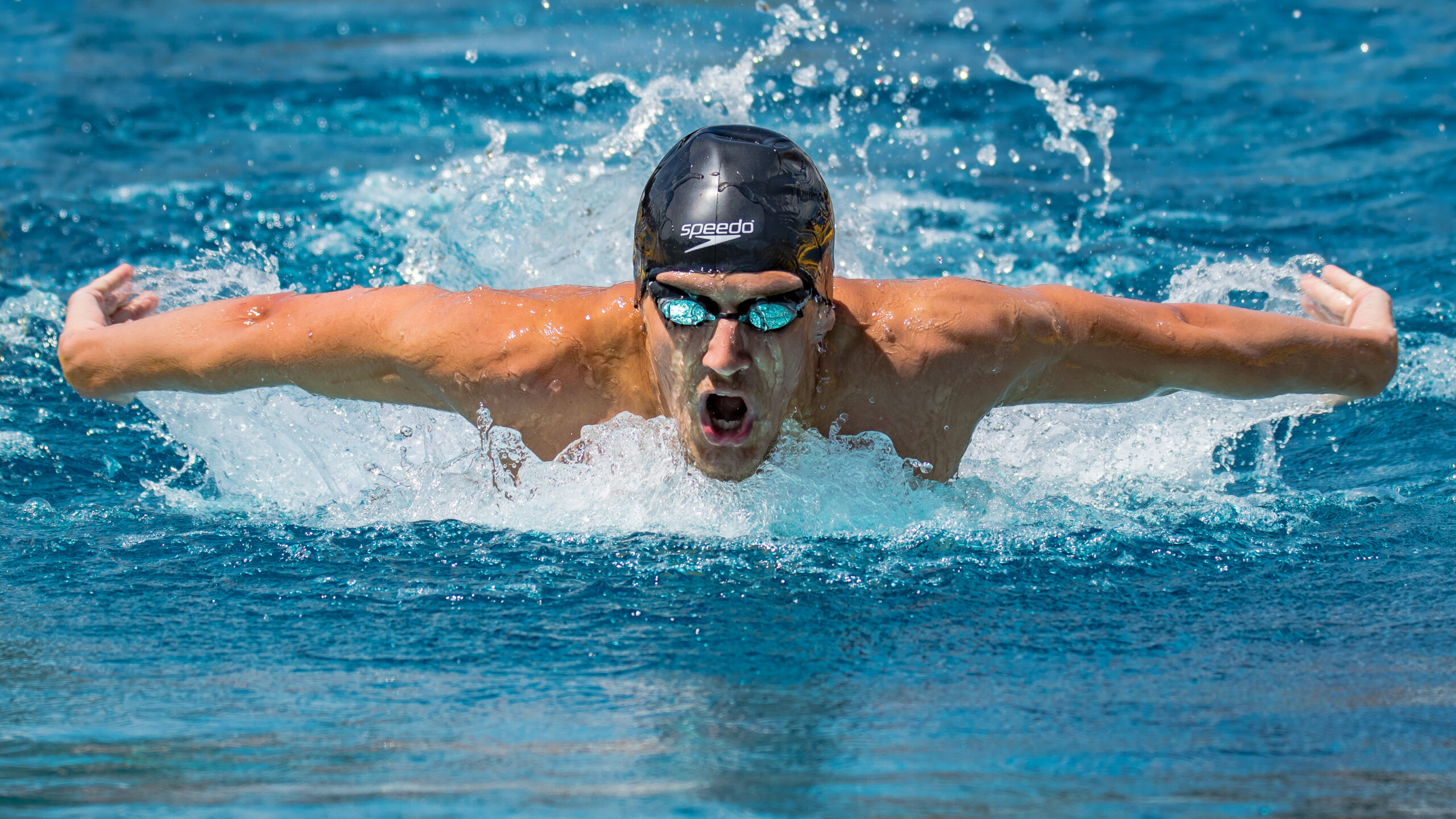 a man doing butterfly strokes in the pool