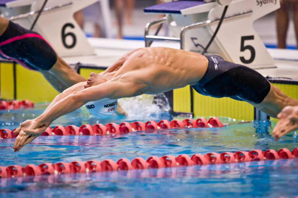 two men swimming showing the concept of Success in Swimming Clubs